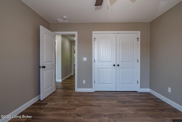 unfurnished bedroom featuring a closet, dark hardwood / wood-style floors, and ceiling fan