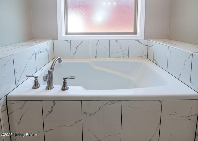 bathroom featuring tiled tub