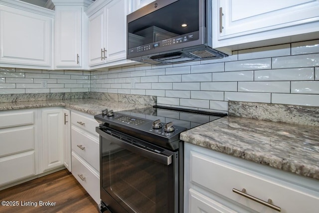 kitchen with white cabinetry, light stone countertops, backsplash, and black range with electric cooktop