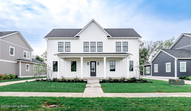 modern farmhouse with a porch and a front lawn