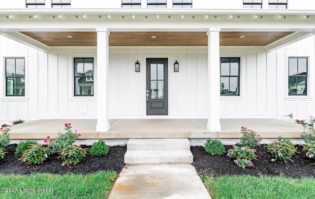 view of exterior entry with a porch