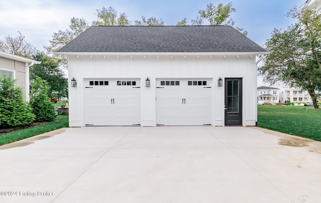 garage featuring a lawn