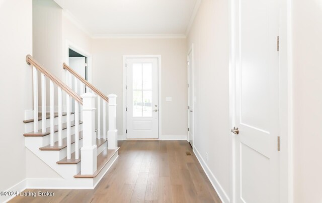 entrance foyer featuring hardwood / wood-style floors and crown molding