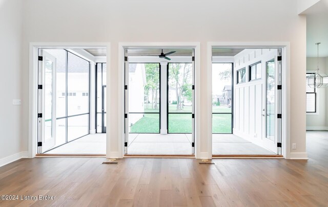 doorway to outside featuring ceiling fan and light hardwood / wood-style flooring