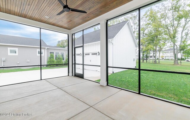 unfurnished sunroom featuring wooden ceiling and ceiling fan