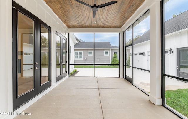 unfurnished sunroom featuring ceiling fan and wood ceiling