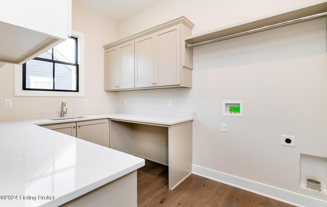 clothes washing area featuring sink, cabinets, washer hookup, electric dryer hookup, and dark wood-type flooring