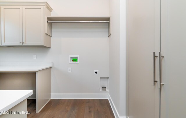 laundry area with dark wood-type flooring, cabinets, washer hookup, and hookup for an electric dryer