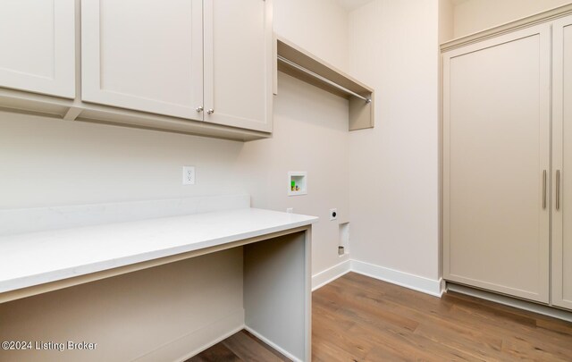 laundry room featuring cabinets, wood-type flooring, washer hookup, and hookup for an electric dryer