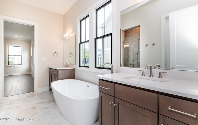 bathroom featuring vanity and shower with separate bathtub