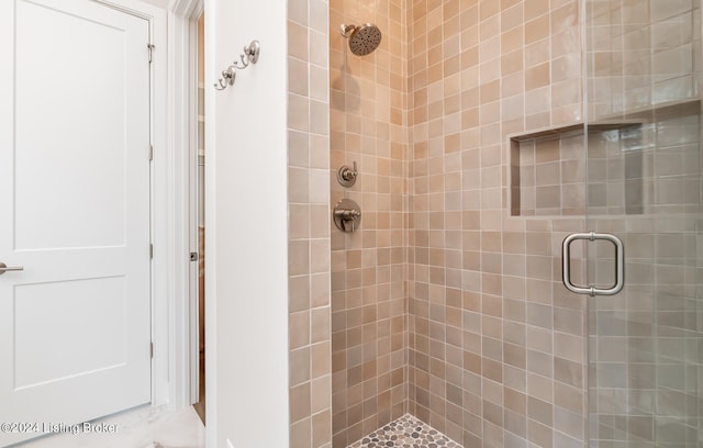 bathroom featuring a shower with shower door