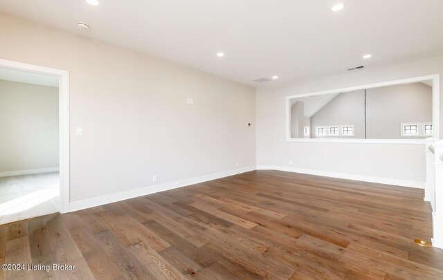 spare room with dark hardwood / wood-style flooring