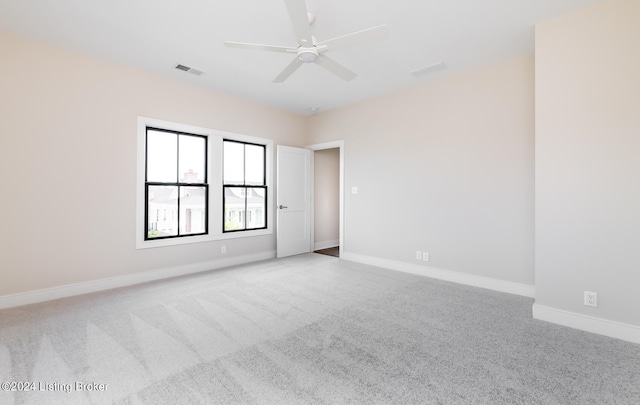 unfurnished room with ceiling fan and carpet flooring