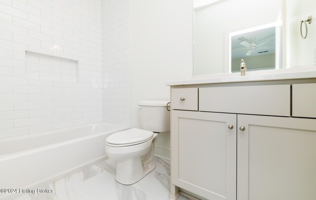 full bathroom featuring tiled shower / bath combo, vanity, ceiling fan, and toilet