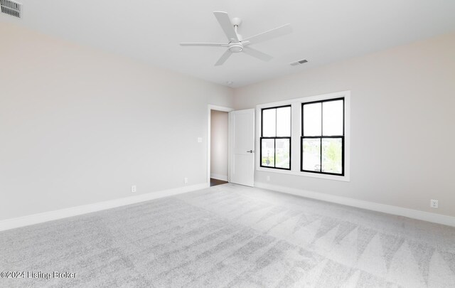 unfurnished room with ceiling fan and light carpet