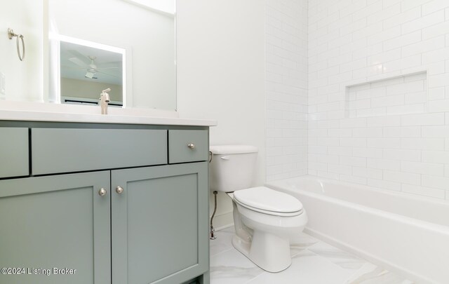 full bathroom with vanity, tiled shower / bath combo, and toilet