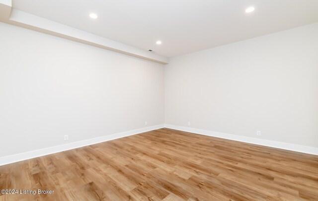 spare room with hardwood / wood-style floors