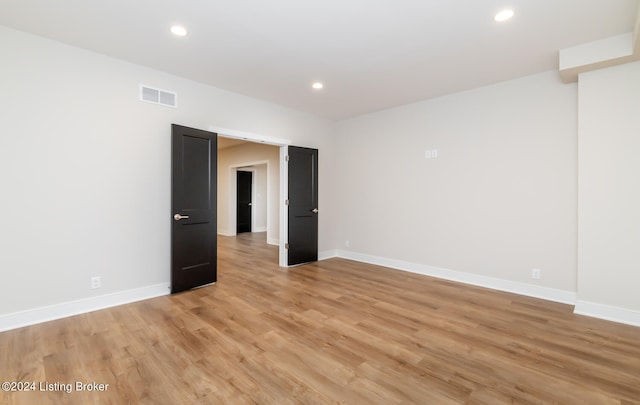 unfurnished room with light wood-type flooring