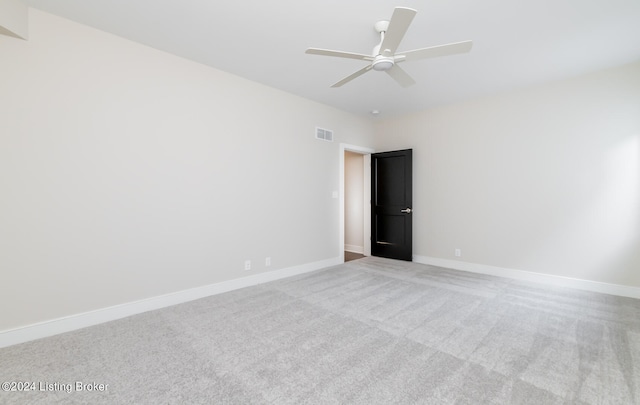 carpeted spare room with ceiling fan