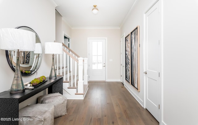 entryway with hardwood / wood-style flooring and ornamental molding