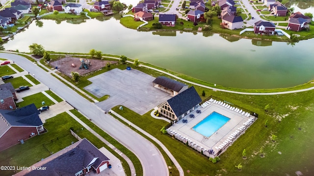 drone / aerial view featuring a residential view and a water view