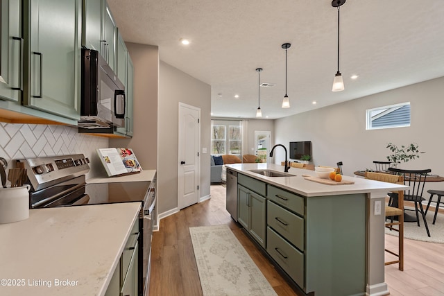 220 Harvest Moon Ct Unit 215B, Shepherdsville, KY 40165 - kitchen featuring green cabinets, appliances with stainless steel finishes, a sink, tasteful backsplash, and light countertops