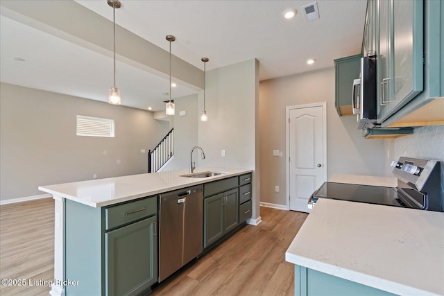 120 Exploration Path Unit 5B, Shelbyville, KY 40065 - kitchen featuring appliances with stainless steel finishes, a sink, light wood-style floors, baseboards, and pendant lighting