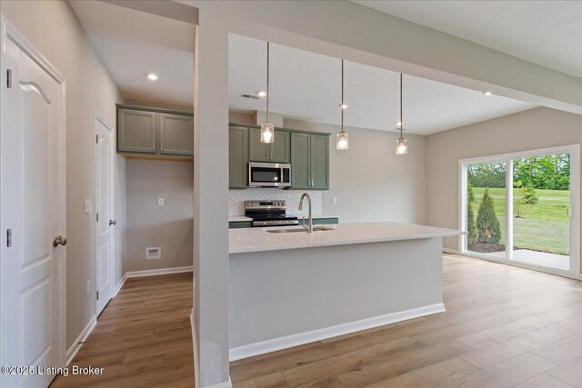 120 Exploration Path Unit 5B, Shelbyville, KY 40065 - kitchen with stainless steel appliances, a sink, light wood-style floors, light countertops, and decorative backsplash