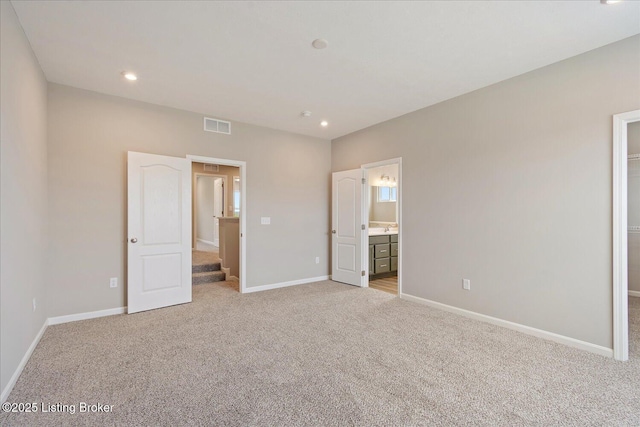 120 Exploration Path Unit 5B, Shelbyville, KY 40065 - unfurnished bedroom featuring light carpet, baseboards, recessed lighting, and ensuite bath
