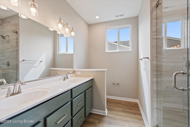 120 Exploration Path Unit 5B, Shelbyville, KY 40065 - bathroom featuring healthy amount of natural light, double vanity, a shower stall, wood finished floors, and recessed lighting