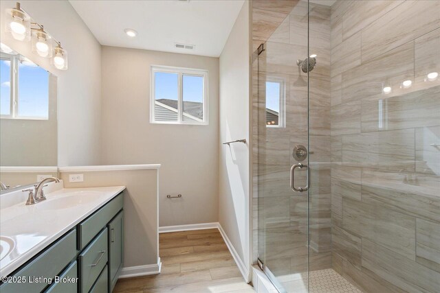 120 Exploration Path Unit 5B, Shelbyville, KY 40065 - bathroom featuring double vanity, a shower stall, wood finished floors, and baseboards
