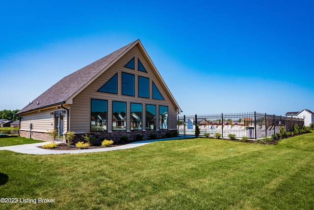 view of front of home with fence and a front lawn