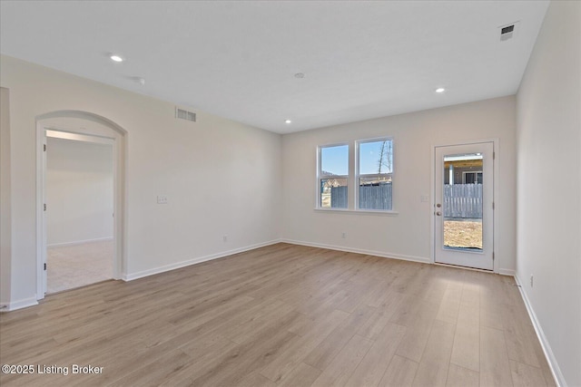 unfurnished room with recessed lighting, visible vents, and light wood-style floors