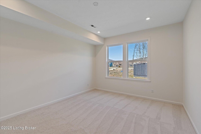 unfurnished room with light carpet, recessed lighting, visible vents, and baseboards