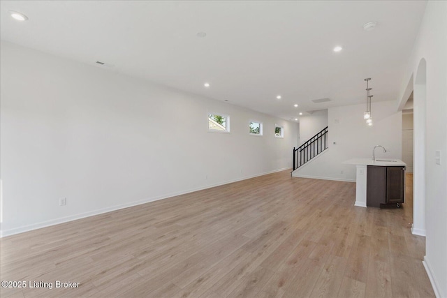 188 Harvest Moon Ct Unit 219B, Shepherdsville, KY 40165 - unfurnished living room featuring a sink, light wood-style floors, recessed lighting, stairs, and baseboards