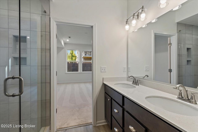 188 Harvest Moon Ct Unit 219B, Shepherdsville, KY 40165 - bathroom with baseboards, wood finished floors, double vanity, and a tile shower