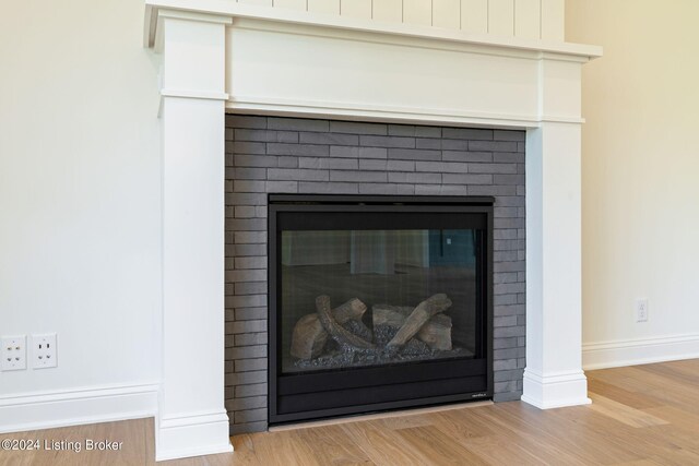6712 Hypoint Ridge Rd, Crestwood, KY 40014 - details with baseboards, wood finished floors, and a brick fireplace