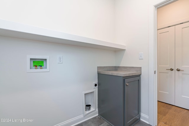 laundry area featuring washer hookup, wood-type flooring, cabinets, and hookup for an electric dryer