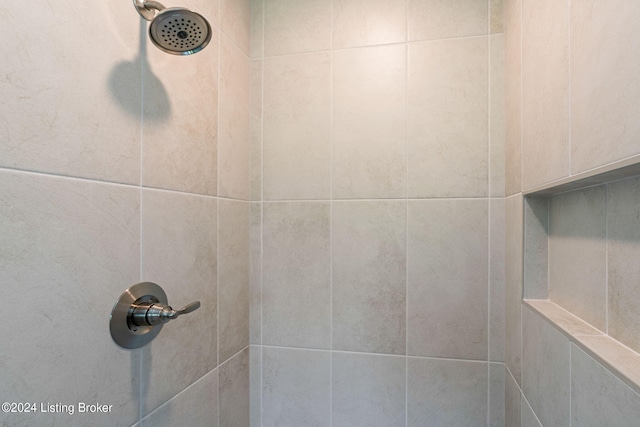 interior details with a tile shower