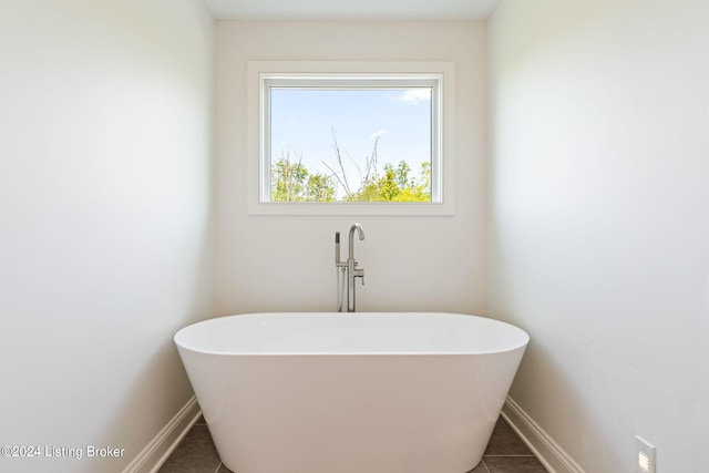 bathroom featuring a tub to relax in and tile patterned floors