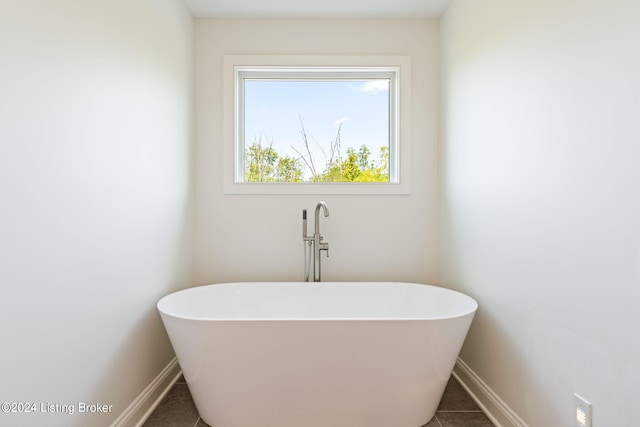 6712 Hypoint Ridge Rd, Crestwood, KY 40014 - bathroom featuring tile patterned flooring, a freestanding tub, and baseboards