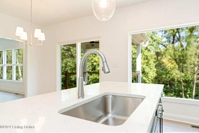 kitchen with plenty of natural light, decorative light fixtures, and sink