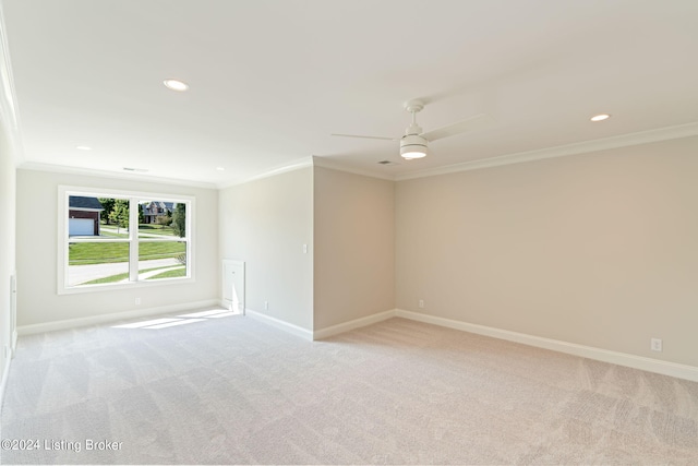 carpeted spare room with crown molding and ceiling fan