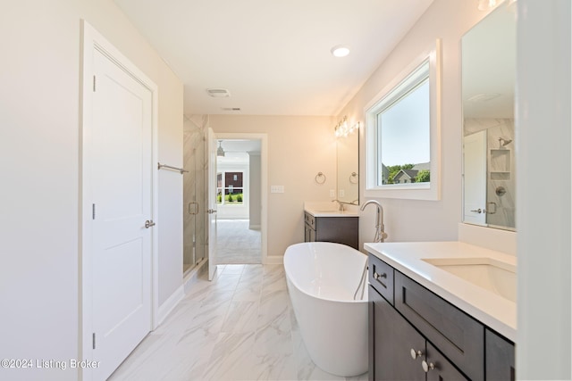 bathroom featuring vanity, plenty of natural light, and shower with separate bathtub