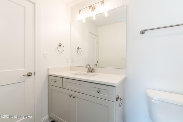 bathroom featuring toilet and vanity