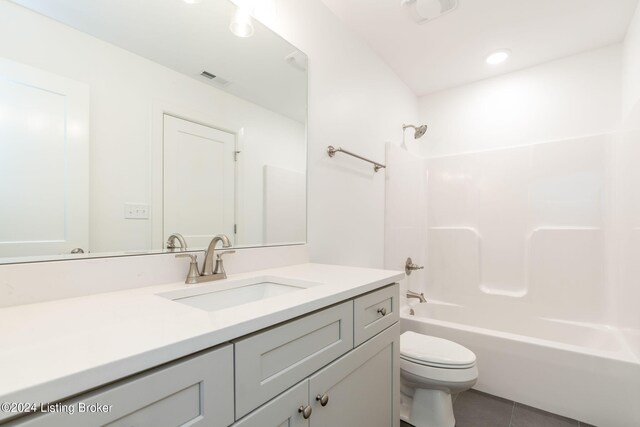 full bathroom featuring tile patterned flooring, vanity, toilet, and shower / bathtub combination