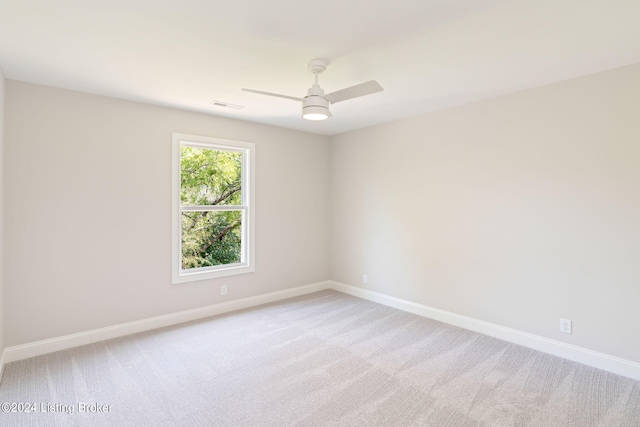 empty room with light colored carpet and ceiling fan