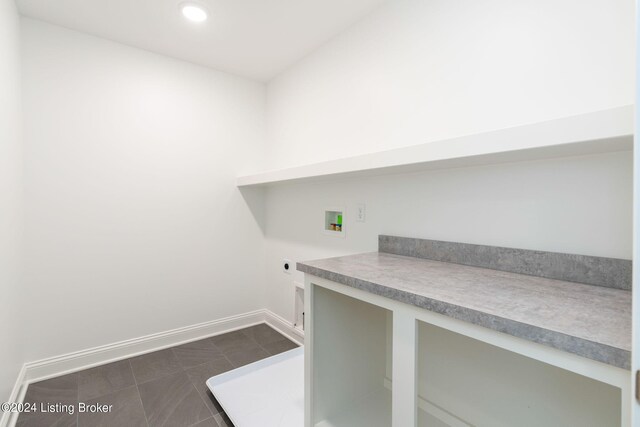 unfurnished office featuring dark tile patterned floors