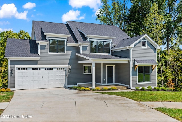 view of front of property with a garage and a front yard