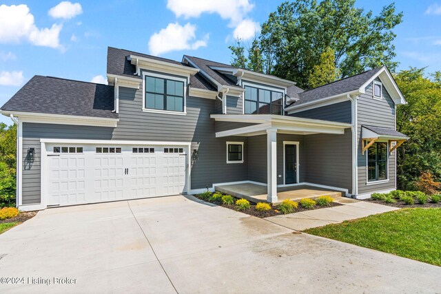 view of front of property with a garage and a porch